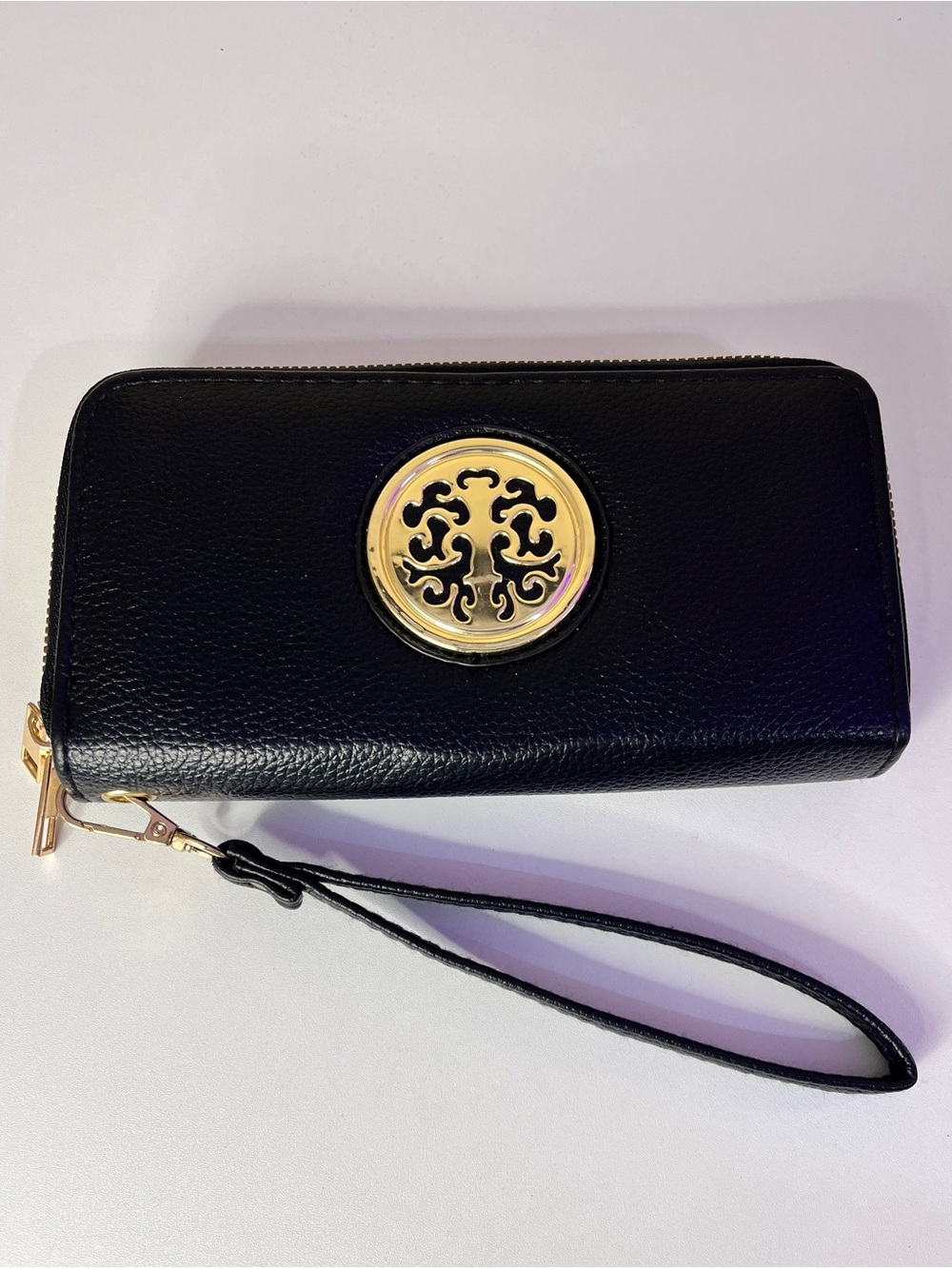 SUGU Black Leather Wristlet Clutch with Gold Emblem